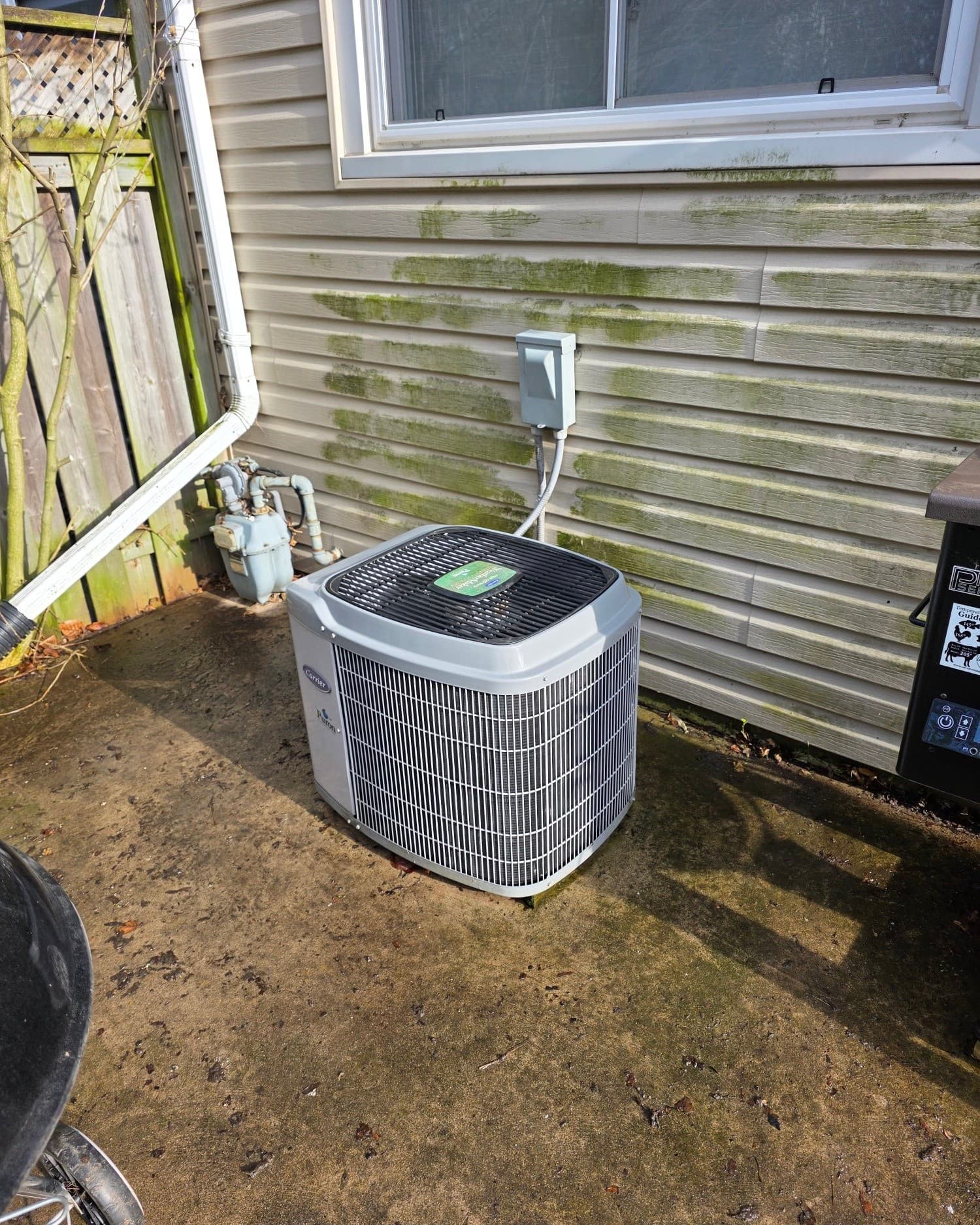 Outdoor AC condenser unit during mid-season diagnostic visit